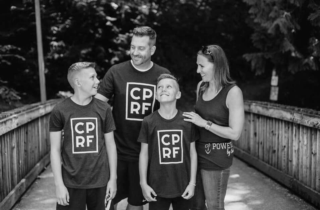 The Randall family posing ourtside on a bridge wearing CPR shirts