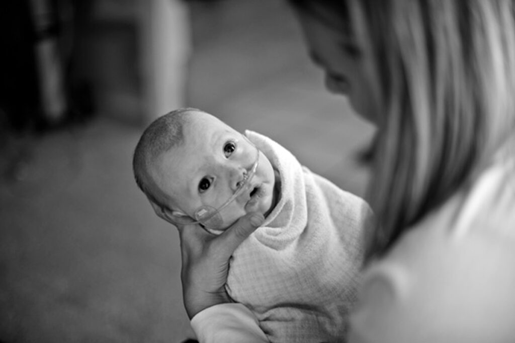 Shawna Randall holding baby Cole in her hands