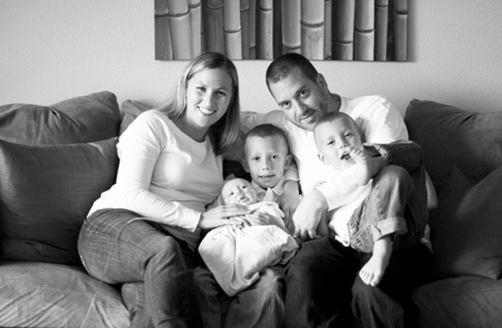 The Randall family sitting on a couch and holding baby Cole Parker Randall