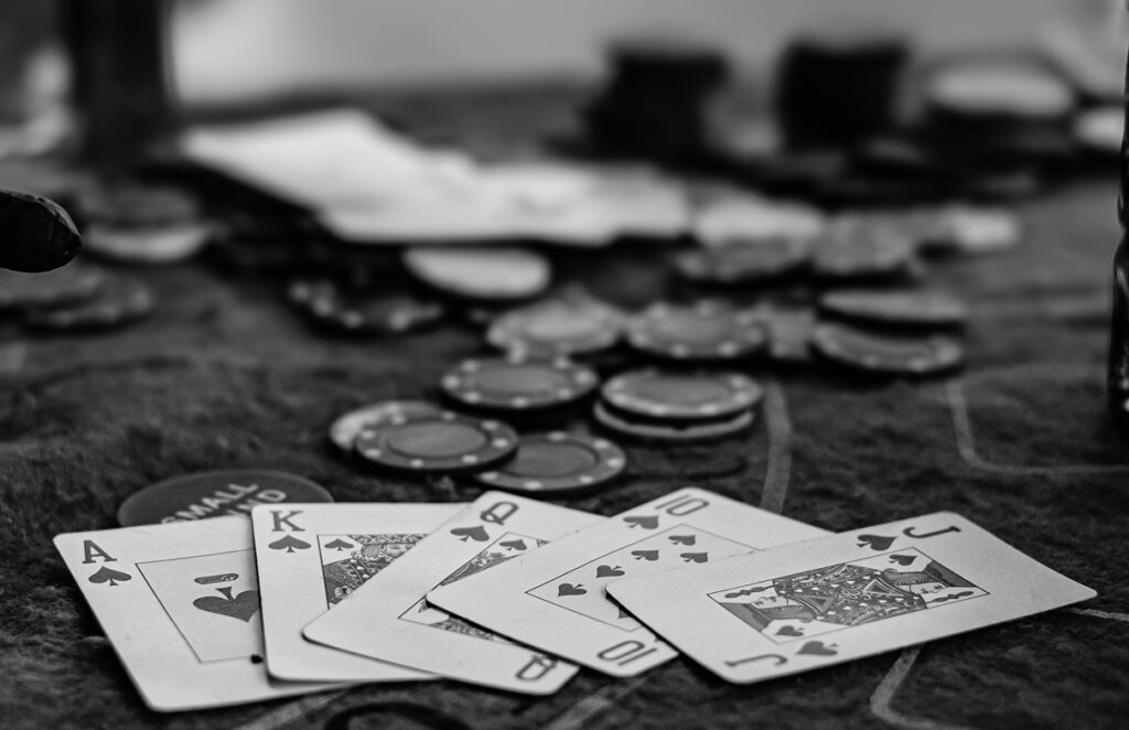 close up image of playing cards an dpoker chips on a table